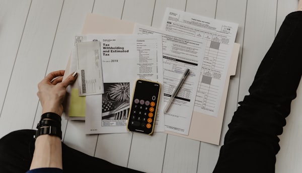 Person reviewing financial statements while learning RBI fair-practice borrower rights